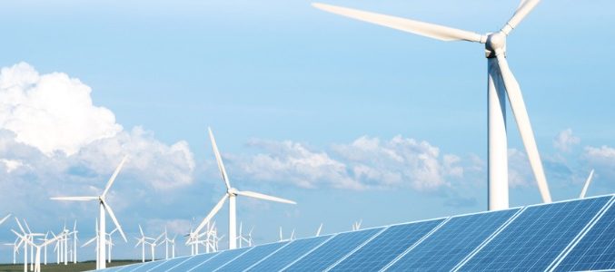 solar-panel-in-green-lawn-with-wind-power-station-picture-id637732264
