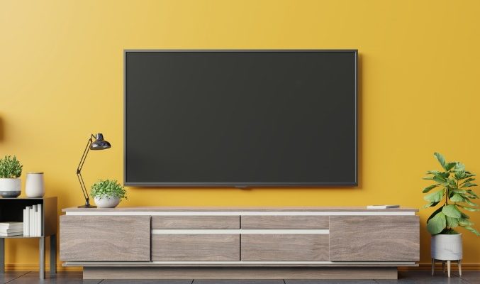 on-cabinet-in-modern-living-room-on-yellow-wall-background-picture-id1182345601